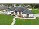 Stunning home featuring a white exterior, manicured lawn, complemented by a beautiful landscape and walkway at 1148 Rosetta Dr, Deltona, FL 32725