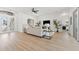 Bright, open-concept living room boasts wood flooring, neutral decor, and views to the bedroom at 1148 Rosetta Dr, Deltona, FL 32725