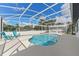 Inviting pool area with a screened enclosure, lounge chairs, and an outdoor bar, perfect for relaxation and entertaining at 1148 Rosetta Dr, Deltona, FL 32725