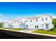 Modern townhome exterior featuring individual garages, private entrances, and landscaped front yards at 1203 Port Blue Way, Lady Lake, FL 32159