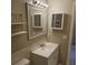 Cozy bathroom featuring a framed mirror, modern lighting, shelving and a white vanity at 2200 S Palmetto Ave # E050, South Daytona, FL 32119