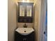 Well-lit bathroom with a stylish vanity, mirrored cabinet, and ample storage at 2200 S Palmetto Ave # E050, South Daytona, FL 32119