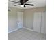 Bedroom with neutral walls, tile flooring, ceiling fan, and a closet with sliding doors at 2200 S Palmetto Ave # E050, South Daytona, FL 32119
