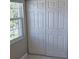 Bedroom closet features white paneled sliding doors next to a window at 2200 S Palmetto Ave # E050, South Daytona, FL 32119
