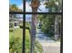Outdoor view through a window showcasing a palm tree, a driveway, and waterfront property at 2200 S Palmetto Ave # E050, South Daytona, FL 32119