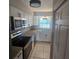 Efficient kitchen featuring white cabinets, granite countertops, and modern stainless-steel appliances at 2200 S Palmetto Ave # E050, South Daytona, FL 32119