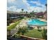 Outdoor view of a community pool with lounge chairs and umbrellas at 2200 S Palmetto Ave # E050, South Daytona, FL 32119