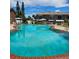 Large, refreshing community pool surrounded by lush greenery and lounge areas for residents to enjoy at 2200 S Palmetto Ave # E050, South Daytona, FL 32119