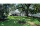 Spacious backyard featuring a large tree, white fence, and lush greenery, ideal for outdoor activities at 423 E Kaley St, Orlando, FL 32806