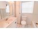 Well-lit bathroom featuring a single sink vanity and standard toilet at 423 E Kaley St, Orlando, FL 32806