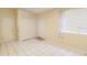 Bedroom featuring tile floors, neutral paint, a large window, and plenty of closet space at 423 E Kaley St, Orlando, FL 32806