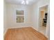 Dining room with wood floors, a decorative glass window, and a view into the adjacent kitchen at 423 E Kaley St, Orlando, FL 32806