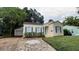 Charming single-story home featuring a stone pathway, well-kept landscaping, and an attached garage at 423 E Kaley St, Orlando, FL 32806