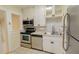 Well-maintained kitchen with stainless steel appliances, white cabinets, and a neutral backsplash at 423 E Kaley St, Orlando, FL 32806