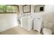 Laundry room with full-size washer and dryer set and a toilet at 423 E Kaley St, Orlando, FL 32806