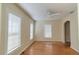 Bright and airy living room with wood floors, neutral paint, a ceiling fan, and plenty of natural light at 423 E Kaley St, Orlando, FL 32806