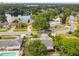 Aerial view of a neighborhood with tree-lined streets and a lake in the background at 7289 Lake Floy Cir, Orlando, FL 32819