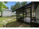 View of the backyard featuring a screened patio, a shed, and a fenced perimeter, offering a private outdoor space at 7289 Lake Floy Cir, Orlando, FL 32819