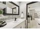 This stylish bathroom features gorgeous tile, updated fixtures, and a doorway view of the kitchen at 7289 Lake Floy Cir, Orlando, FL 32819