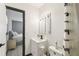 Bright bathroom with a modern vanity, mirrored cabinet, and tiled floor, located adjacent to a bedroom at 7289 Lake Floy Cir, Orlando, FL 32819