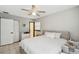 This well-lit bedroom has a ceiling fan and a white bed with matching dresser at 7289 Lake Floy Cir, Orlando, FL 32819
