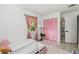 Bright bedroom with pink accents and a view of the window at 7289 Lake Floy Cir, Orlando, FL 32819