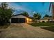 Charming single-story home with a two-car garage and well-manicured front yard at 7289 Lake Floy Cir, Orlando, FL 32819