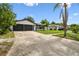 Exterior view of the home, with a two car garage and nicely kept lawn at 7289 Lake Floy Cir, Orlando, FL 32819