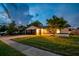 Home exterior with a well-manicured lawn, and a two car garage at 7289 Lake Floy Cir, Orlando, FL 32819