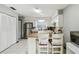 Bright kitchen featuring white cabinetry, stainless steel appliances, and a charming breakfast bar with seating at 7289 Lake Floy Cir, Orlando, FL 32819