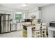 Clean kitchen with stainless steel appliances and a cozy island seating area at 7289 Lake Floy Cir, Orlando, FL 32819