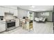 Open kitchen connects to the dining area, featuring stainless steel appliances and a convenient breakfast bar at 7289 Lake Floy Cir, Orlando, FL 32819