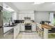 Bright kitchen with white cabinetry, stainless steel appliances, and a cozy breakfast nook with counter seating at 7289 Lake Floy Cir, Orlando, FL 32819