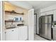 Functional laundry area with a washer, dryer, and shelving for storage, conveniently located near the kitchen at 7289 Lake Floy Cir, Orlando, FL 32819