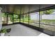 Relaxing screened patio with tile flooring, offering views of the backyard and a shed for storage at 7289 Lake Floy Cir, Orlando, FL 32819
