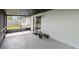 Relaxing screened patio with tile flooring, offering access to the yard and a tranquil outdoor space at 7289 Lake Floy Cir, Orlando, FL 32819