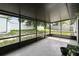 Spacious screened patio with tile floor, providing a comfortable transition between indoor and outdoor living spaces and a spacious yard at 7289 Lake Floy Cir, Orlando, FL 32819