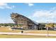 Lakeside community amphitheater with a unique sunshade design sits amongst large green space and sidewalk access at 741 Mystic Gardens Dr, Apopka, FL 32703