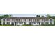 Newly constructed townhomes with modern gray siding, a brown roof, and well-manicured landscaping at 761 Mystic Gardens Dr, Apopka, FL 32703
