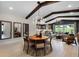 Open concept living space featuring exposed beams, modern lighting, and a view to the backyard at 764 Mystic Gardens Dr, Apopka, FL 32703