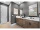 This bathroom features a double vanity with dark fixtures, neutral walls, and a private water closet at 847 Emerald Grove Dr, Apopka, FL 32703