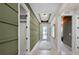 Bright hallway with decorative wall paneling, recessed lighting, and access to rooms at 847 Emerald Grove Dr, Apopka, FL 32703