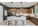 Modern kitchen with stylish lighting, stainless steel appliances, an island, and barstool seating at 847 Emerald Grove Dr, Apopka, FL 32703