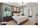This main bedroom features a neutral color palette, a platform bed, decorative light fixture, and large windows at 847 Emerald Grove Dr, Apopka, FL 32703