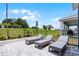 This backyard has three lounge chairs, a fence, and a green space at 855 Emerald Grove Dr, Apopka, FL 32703