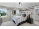 Cool bedroom with sports accents, striped walls, and two windows providing natural light at 855 Emerald Grove Dr, Apopka, FL 32703