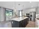 Bright kitchen offers modern appliances, a large island with seating, and plenty of natural light at 855 Emerald Grove Dr, Apopka, FL 32703