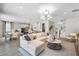 Bright living space features modern furnishings and an open layout with views into the kitchen and dining areas at 855 Emerald Grove Dr, Apopka, FL 32703