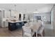 Open-concept living area features a stylish dining table, kitchen island with seating, and a cozy living space at 855 Emerald Grove Dr, Apopka, FL 32703
