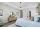 Bright main bedroom featuring a modern chandelier, view to hall and bath, with a stylish console table at 855 Emerald Grove Dr, Apopka, FL 32703